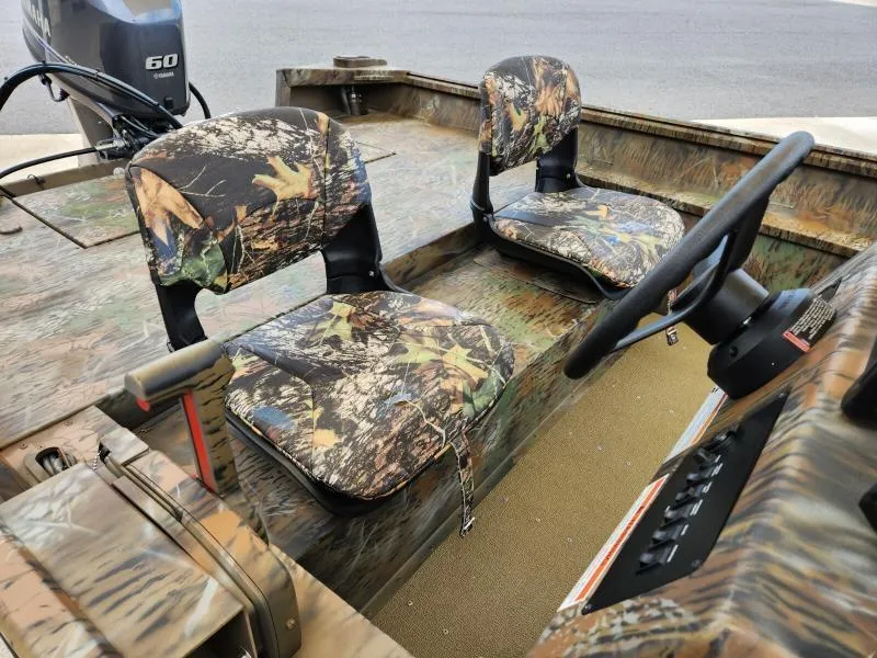 Slide: The Image of 2024 G3 17 SC boat interior with camouflage seats and steering wheel. - 22