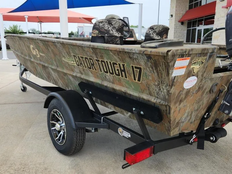 Slide: The Image of 2024 G3 17 SC Gator Tough boat with camouflage design on a trailer. - 7