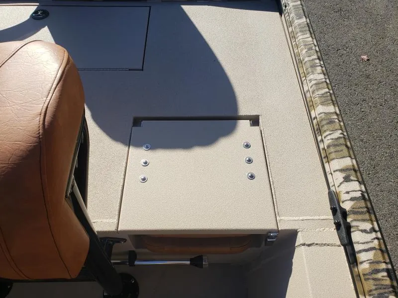 Slide: The Image of 2024 Avid Rogue 20 CC boat interior with tan seat and storage compartment. - 12