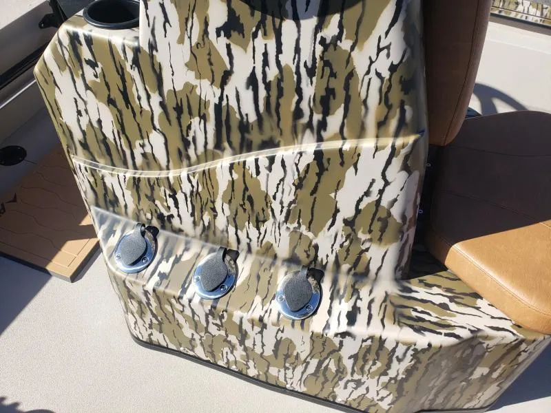 Slide: The Image of 2024 Avid Rogue 20 CC boat console with camouflage design and three cup holders. - 15