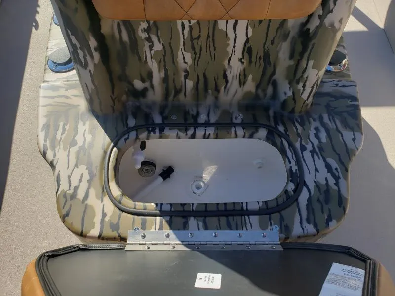 Slide: The Image of 2024 Avid Rogue 20 CC boat interior with camouflage design and storage compartment. - 17