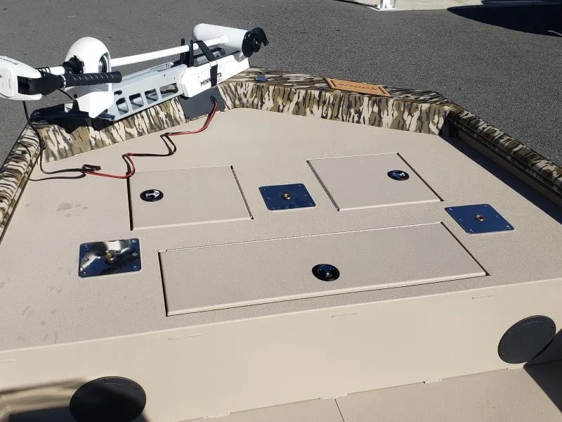 Slide: The Image of 2024 Avid Rogue 20 CC boat deck with storage compartments and trolling motor. - 22