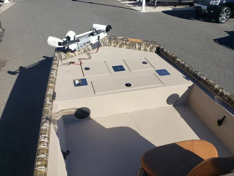 Slide: The Image of 2024 Avid Rogue 20 CC boat interior with camo trim and mounted equipment. - 23