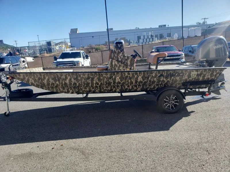 Slide: The Image of 2024 Avid Rogue 20 CC boat with camouflage design on a trailer in a parking lot. - 3