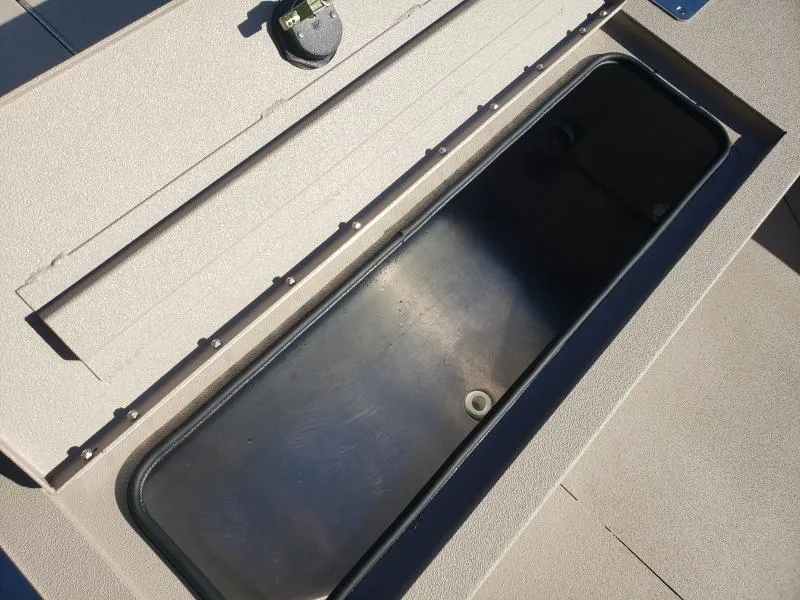 Slide: The Image of 2024 Avid Rogue 20 CC boat storage compartment, open and empty, showcasing interior space. - 8