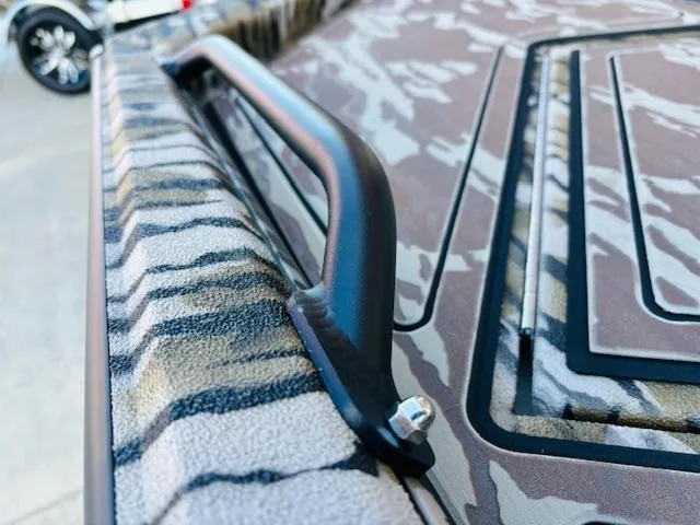 Slide: The Image of Close-up of 2025 Avid 16 Commander boat with camouflage pattern and handle detail. - 10
