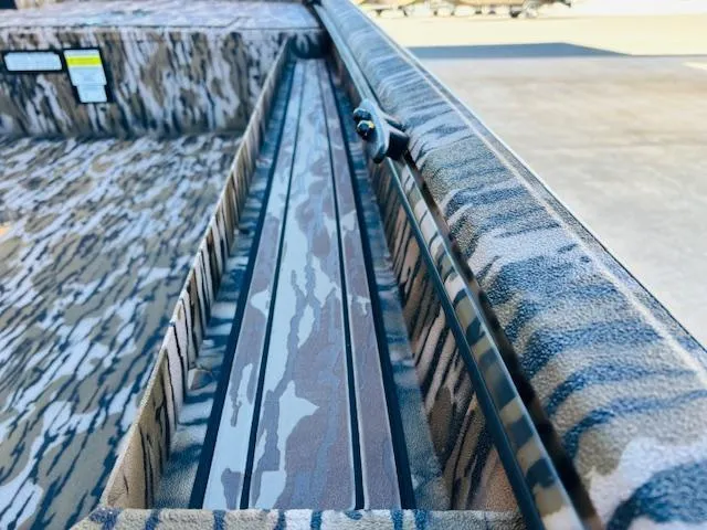 Slide: The Image of Avid 16 Commander 2025 boat interior with camouflage design and detailed texture. - 11