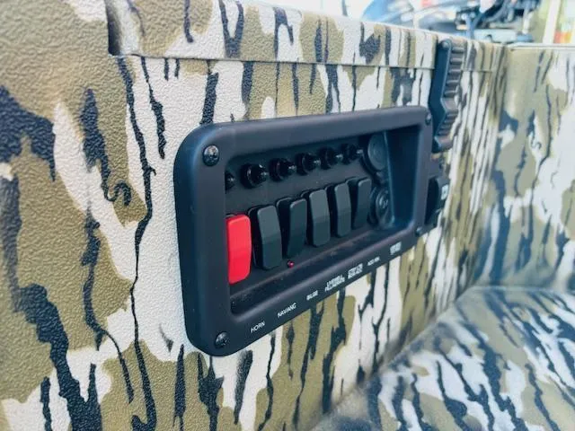 Slide: The Image of Camouflage interior of 2025 Avid 16 Commander boat with control panel. - 13
