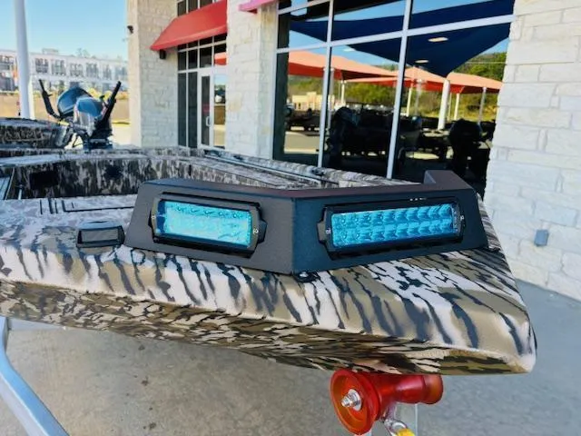 Slide: The Image of 2025 Avid 16 Commander boat with camouflage design and blue LED lights. - 5