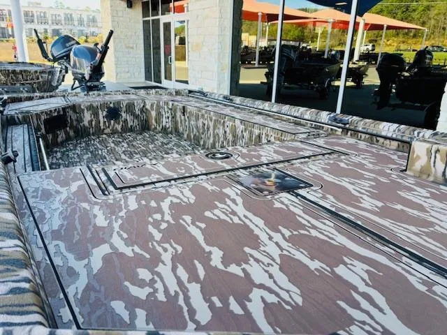 Slide: The Image of 2025 Avid 16 Commander boat with camouflage design, displayed outdoors. - 6