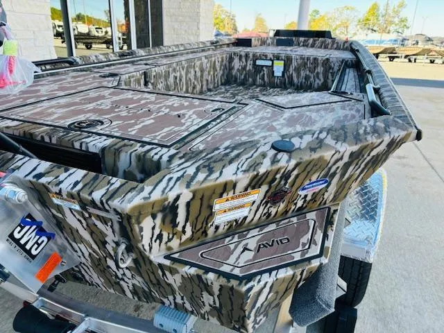 Slide: The Image of 2025 Avid 16 Commander boat with camouflage design on a trailer. - 9