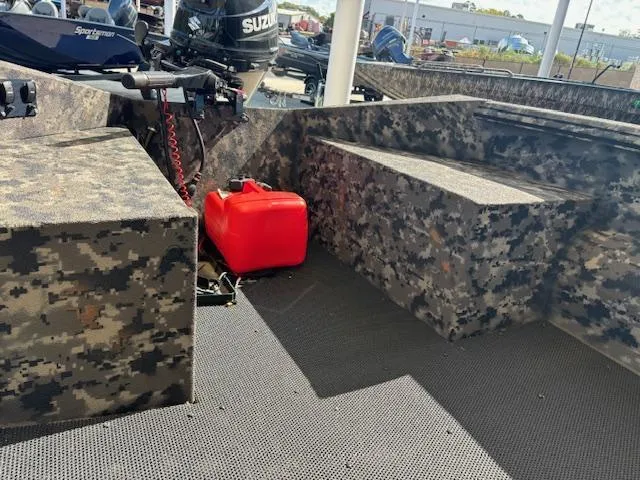 Slide: The Image of 2024 Havoc Boats 1550 VJ interior with camouflage design and red fuel container. - 5