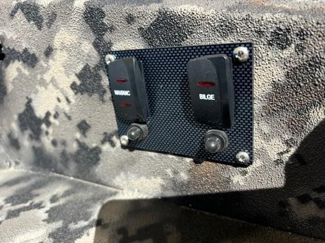 Slide: The Image of Control panel with warning and bilge switches on 2024 Havoc Boats 1550 VJ. - 6
