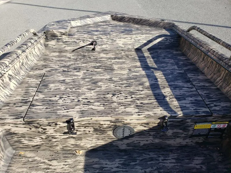 Slide: The Image of 2024 Havoc Boats 1756 Dbst interior with camouflage pattern and storage compartments. - 1