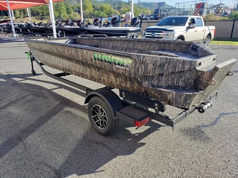 Slide: The Image of 2024 Havoc Boats 1756 Dbst on trailer, camo design, outdoor display. - 14