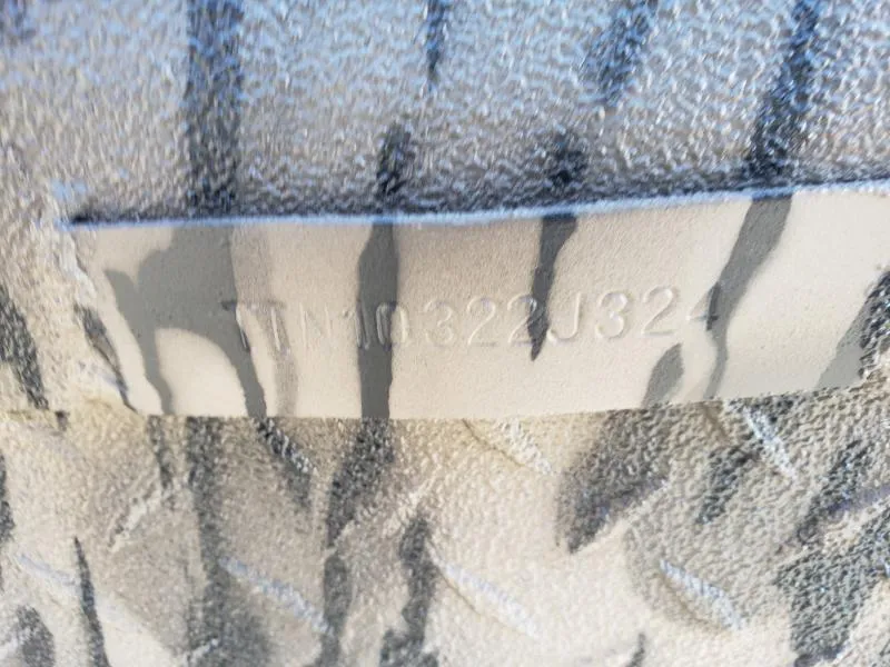 Slide: The Image of 2024 Havoc Boats 1756 Dbst hull identification number on textured surface. - 2