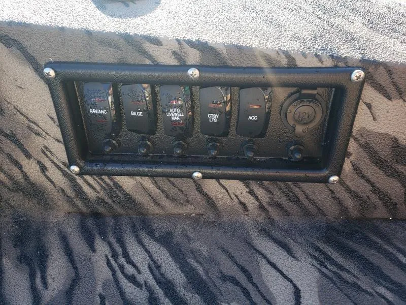 Slide: The Image of Control panel of 2024 Havoc Boats 1756 Dbst with switches and 12V outlet. - 3