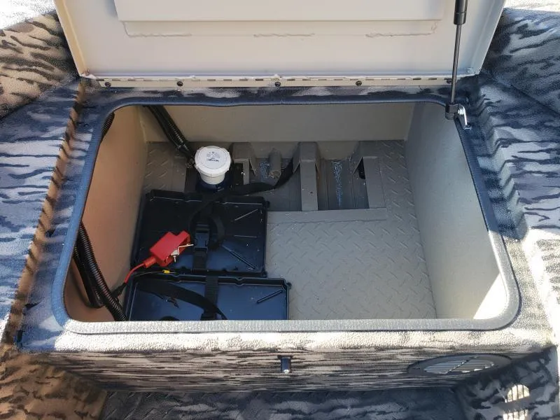 Slide: The Image of Open storage compartment in 2024 Havoc Boats 1756 Dbst, featuring battery and wiring. - 4