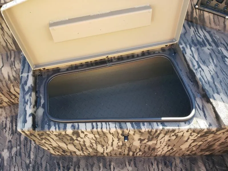 Slide: The Image of 2024 Havoc Boats 1756 Dbst storage compartment with open lid, showcasing interior space. - 6