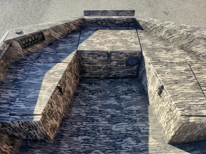 Slide: The Image of 2024 Havoc Boats 1756 Dbst interior with camouflage pattern and storage compartments. - 7