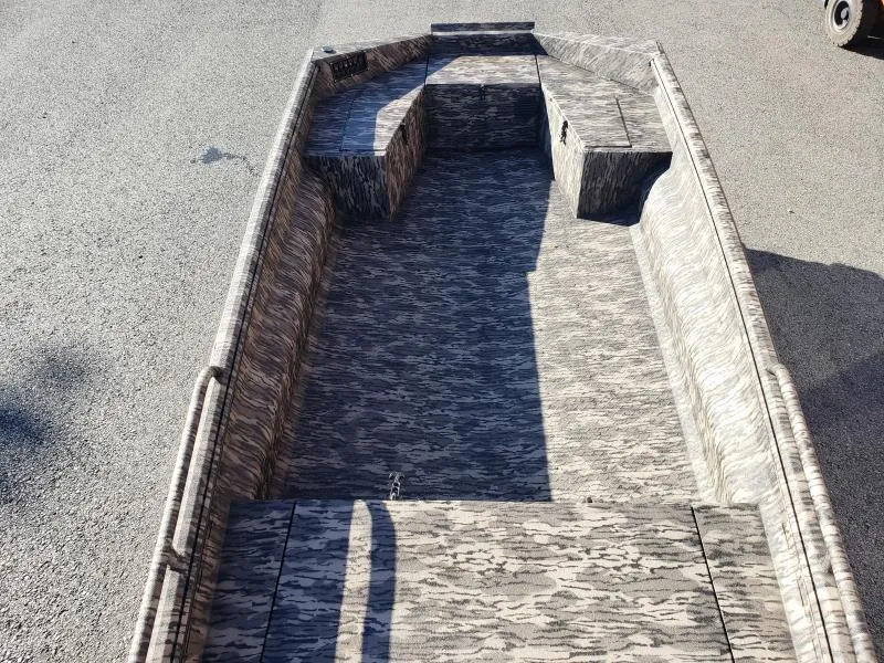 Slide: The Image of 2024 Havoc Boats 1756 Dbst with camouflage interior, parked on pavement. - 8