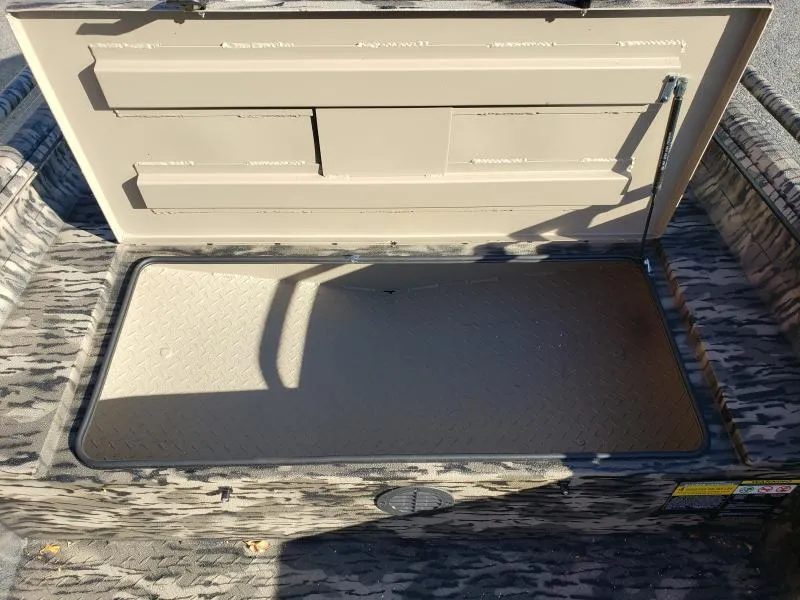 Slide: The Image of 2024 Havoc Boats 1756 Dbst storage compartment with open lid, showcasing interior space. - 9