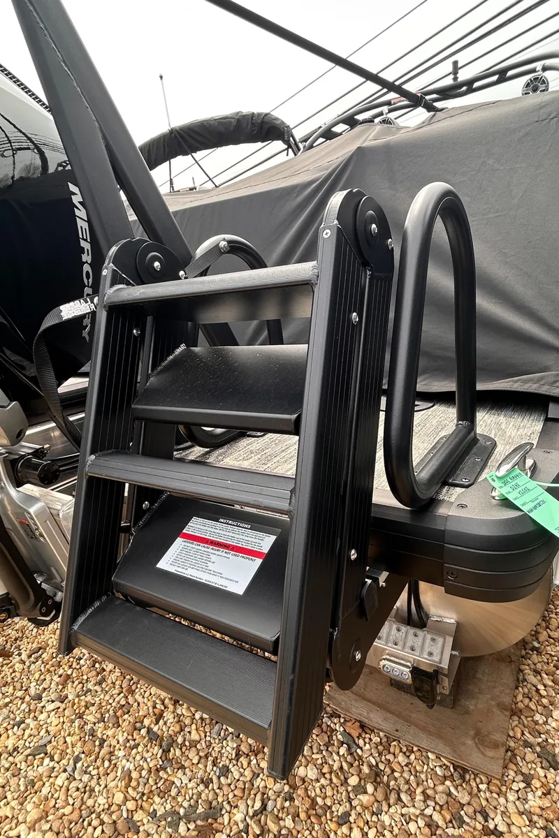 Slide: The Image of Boarding ladder on a 2025 Viaggio Lago X-R boat, shown on gravel surface. - 5