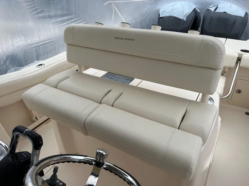 Slide: The Image of 2020 Grady-White 271 Canyon boat interior with cushioned seating and steering wheel. - 3
