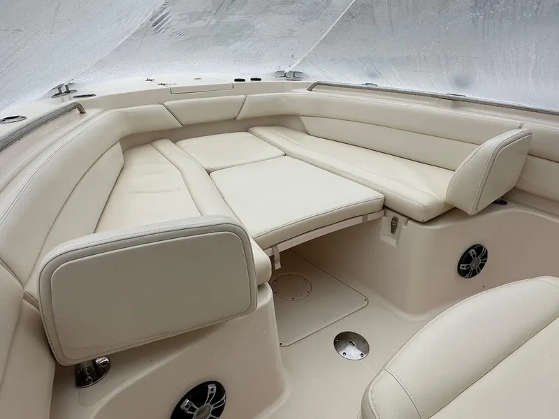 Slide: The Image of 2020 Grady-White 271 Canyon boat interior with beige seating and speakers. - 4