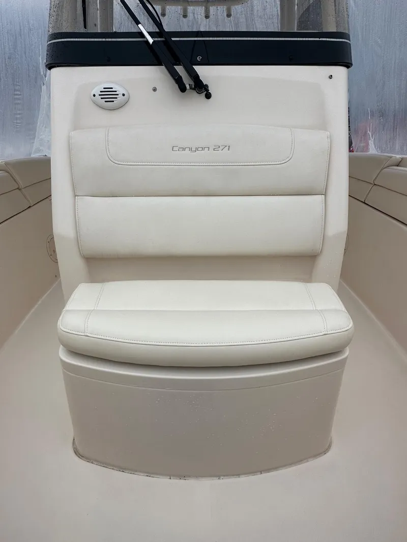 Slide: The Image of 2020 Grady-White 271 Canyon boat seat, featuring sleek white upholstery. - 6