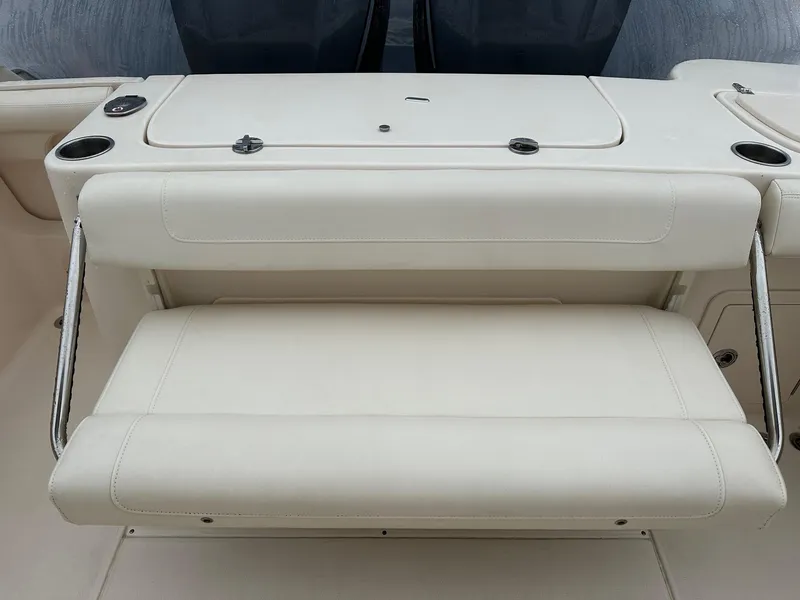 Slide: The Image of 2020 Grady-White 271 Canyon boat seating area with white cushioned bench. - 7