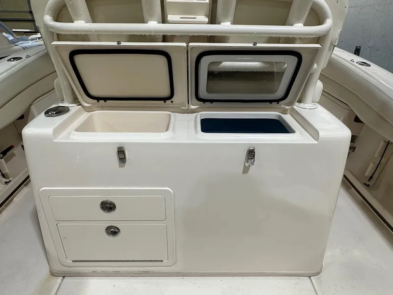 Slide: The Image of 2020 Grady-White 271 Canyon boat interior with storage compartments and drawers. - 8