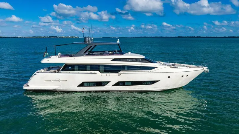 Slide: The Image of 2018 Ferretti Yachts 850 Motor Yacht cruising on clear blue waters under a sunny sky. - 12