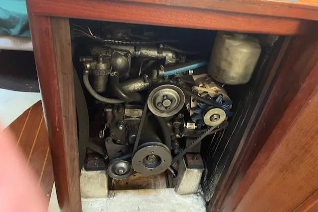 Slide: The Image of Engine compartment of a 1991 Hunter 30T sailboat, showcasing mechanical components. - 14