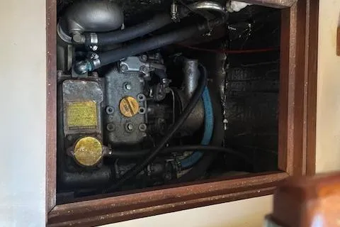 Slide: The Image of Engine compartment of a 1991 Hunter 30T sailboat, showing mechanical components and hoses. - 15