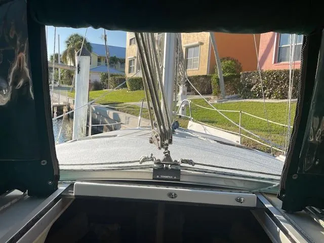 Slide: The Image of Hunter 30T sailboat cockpit view, 1991 model, docked near colorful buildings. - 16