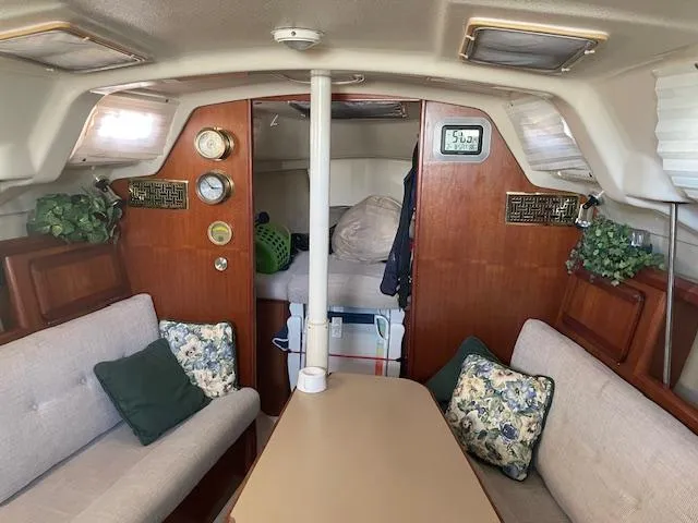 Slide: The Image of Interior of 1991 Hunter 30T sailboat with cozy seating and wooden accents. - 2