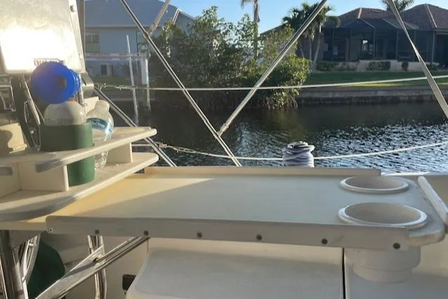 Slide: The Image of Hunter 30T 1991 boat interior with storage shelves, cup holders, and water view. - 20