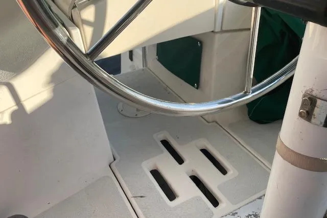 Slide: The Image of Steering wheel of a 1991 Hunter 30T sailboat cockpit, featuring a clean white deck. - 21