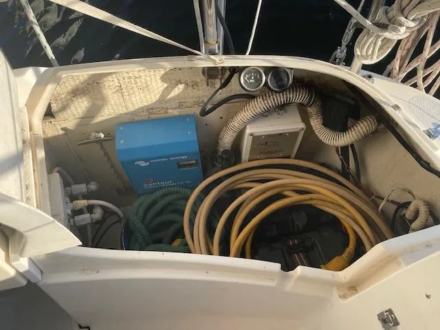 Slide: The Image of Storage compartment of a 1991 Hunter 30T sailboat with hoses and electrical equipment. - 22