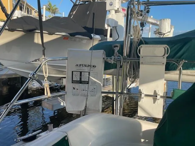 Slide: The Image of Hunter 30T sailboat cockpit, 1991 model, docked with visible safety equipment and marina background. - 27