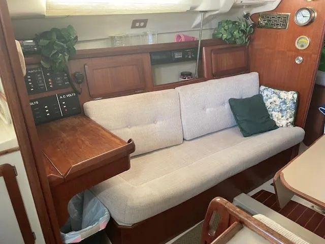 Slide: The Image of Interior of a 1991 Hunter 30T sailboat with a beige sofa and wooden accents. - 3