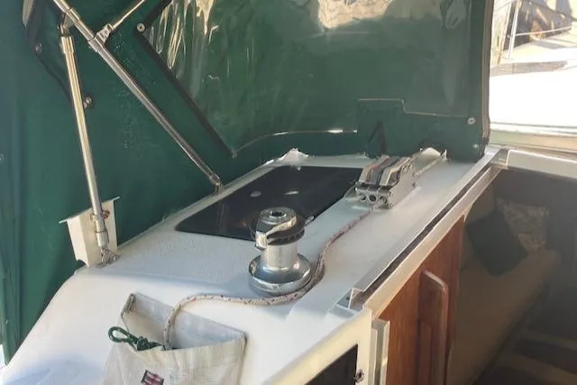 Slide: The Image of 1991 Hunter 30T sailboat cockpit with winch and green canopy. - 31