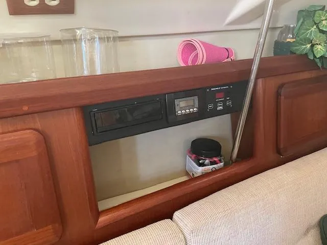 Slide: The Image of Interior of 1991 Hunter 30T sailboat with control panel and wooden cabinetry. - 5