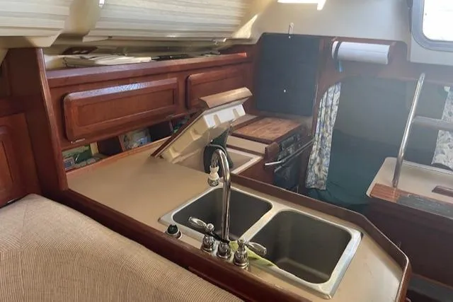 Slide: The Image of Interior of 1991 Hunter 30T sailboat kitchen with sink and wooden cabinetry. - 7