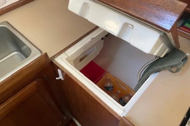 Slide: The Image of Interior of 1991 Hunter 30T boat showing open fridge with drinks inside. - 8