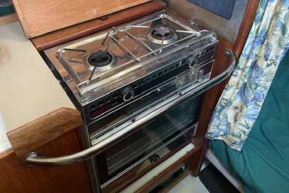 Slide: The Image of 1991 Hunter 30T boat kitchen with a two-burner stove and oven. - 9