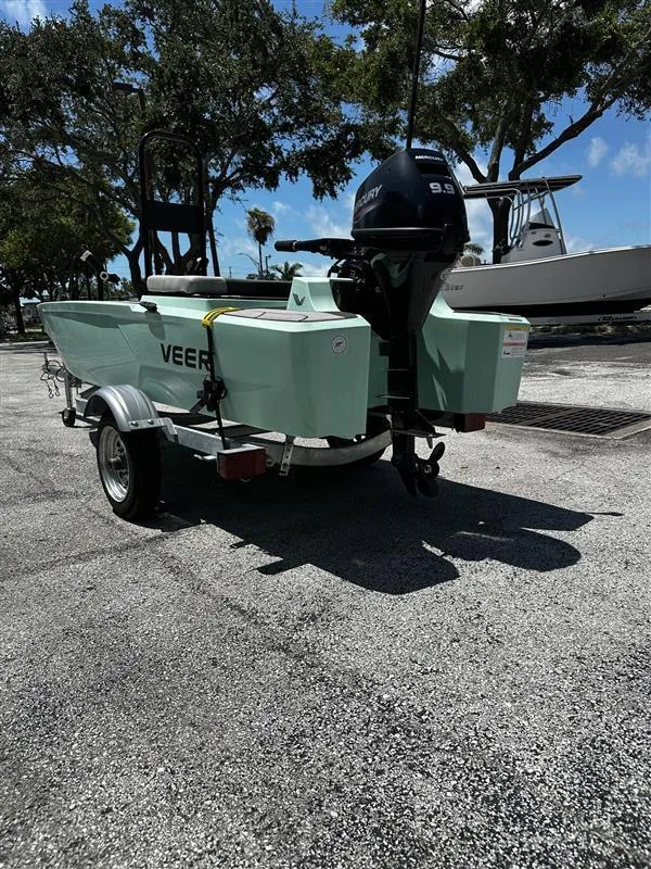 Slide: The Image of 2023 Veer V13 boat on trailer, parked outdoors under clear blue sky. - 4