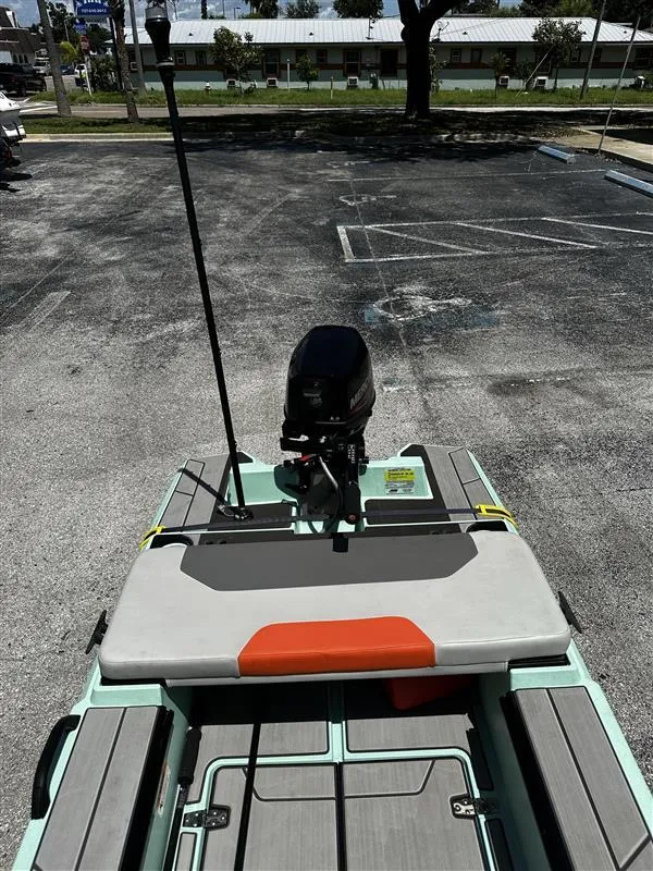 Slide: The Image of 2023 Veer V13 boat parked in a lot, featuring a motor and seating area. - 8