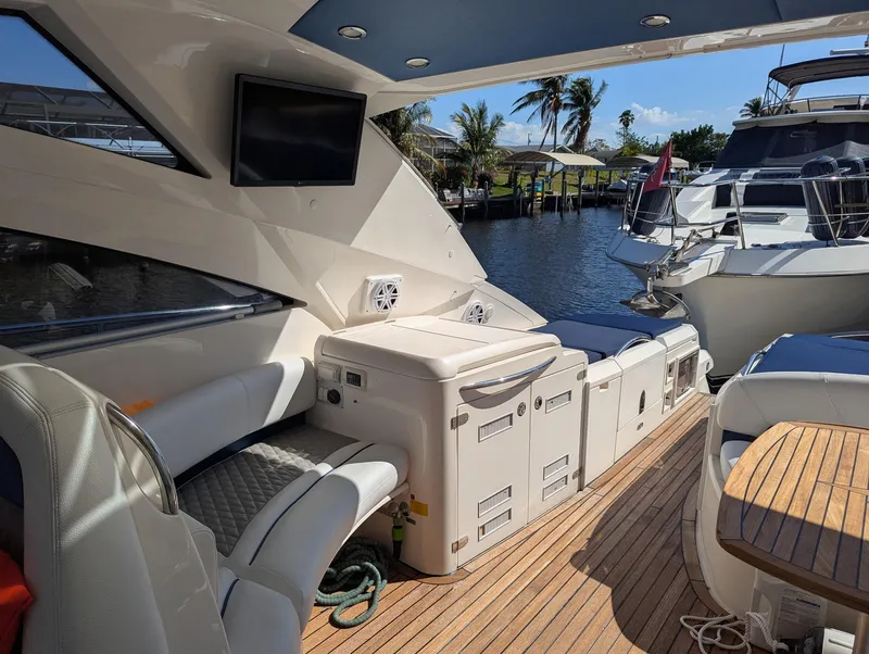 Slide: The Image of 2007 Fairline Targa 52 GT yacht interior with seating, TV, and waterfront view. - 5